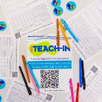 five Teach-In survey papers around a Teach-In flyer, with stickers and pens arranged artfully around them